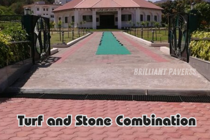 Elegant driveway featuring a creative mix of turf and stone paver blocks leading to a beautiful estate, with the text "Turf and Stone Combination," showcasing Brilliant Paverss' innovative paving solutions that blend greenery and stonework seamlessly in Coimbatore