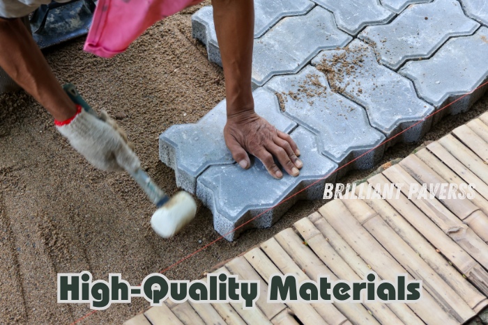 A skilled worker carefully installs interlocking pavers using a rubber mallet, highlighting the high-quality materials provided by Brilliant Paverss in Coimbatore. The image showcases the precision and durability of their paver products, perfect for creating sturdy and aesthetically pleasing outdoor surfaces.